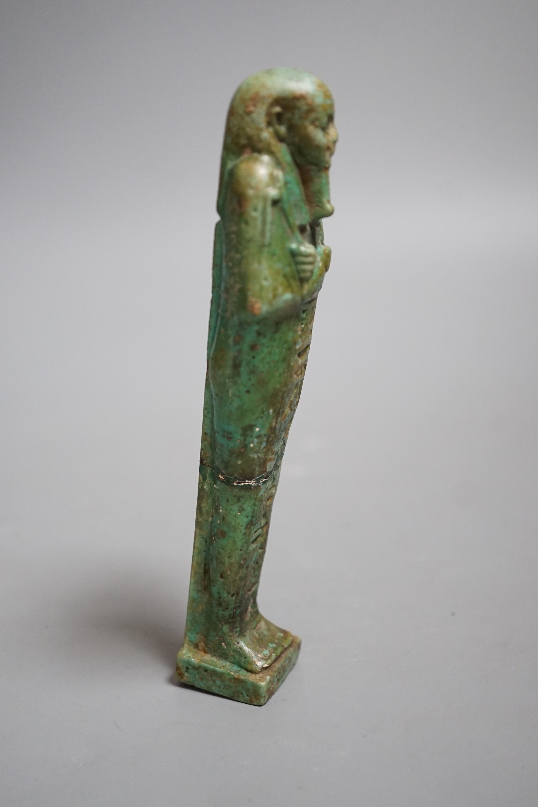 An Egyptian turquoise glazed faience ushabti, possibly Late Kingdom. 14.5cm